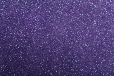 Beautiful shiny violet glitter as background, closeup