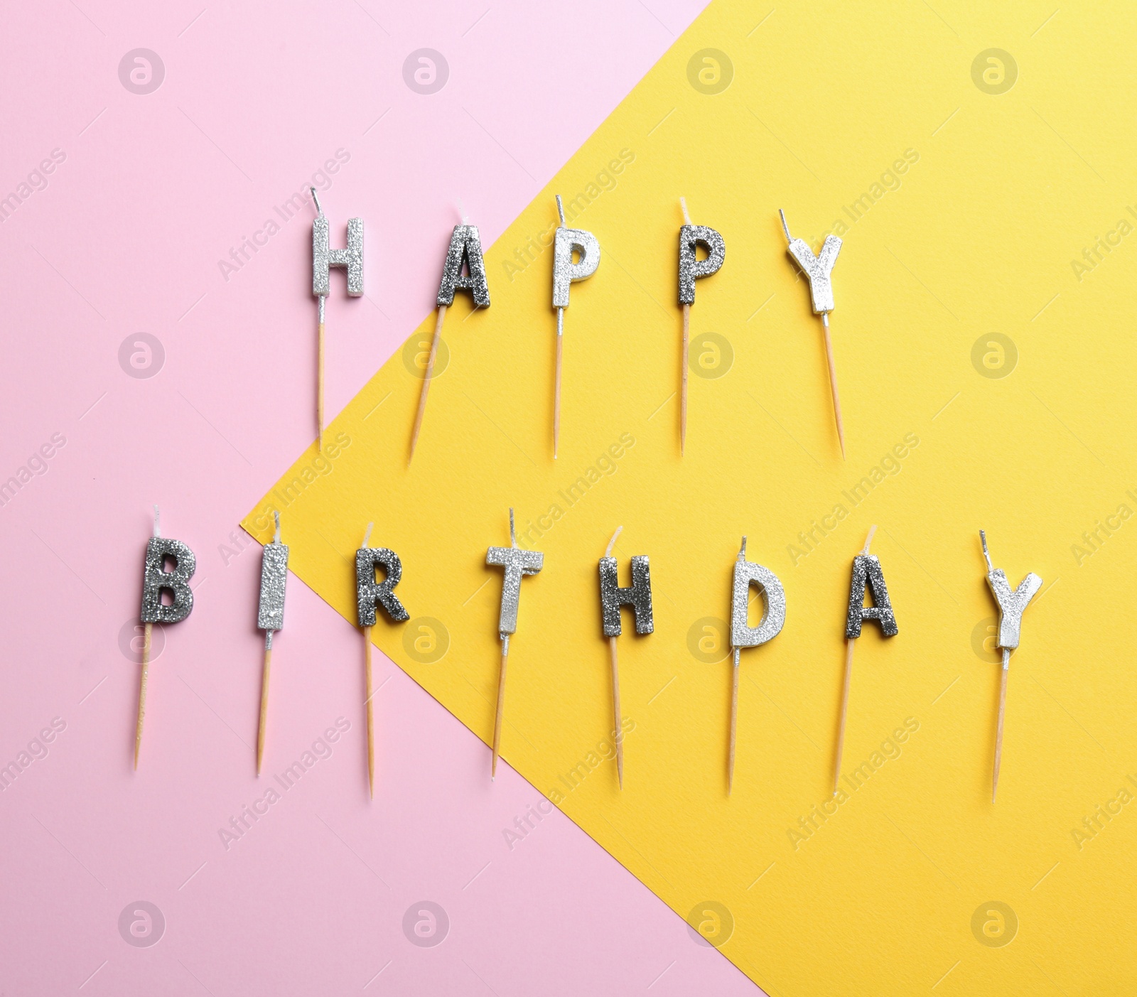 Photo of Flat lay composition with birthday candles on color background