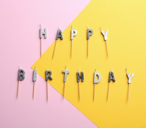 Flat lay composition with birthday candles on color background