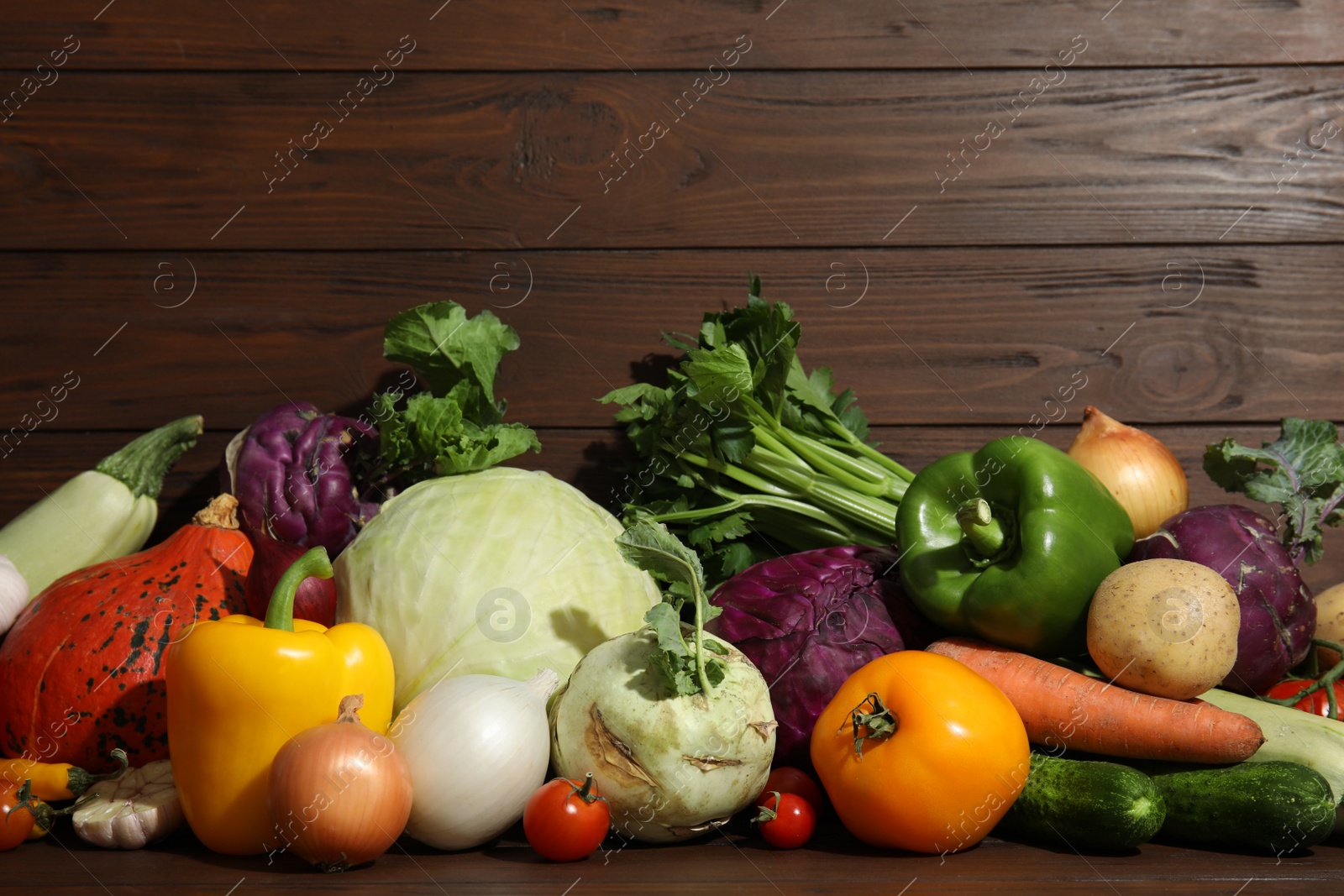 Photo of Many fresh ripe vegetables on wooden background. Organic food