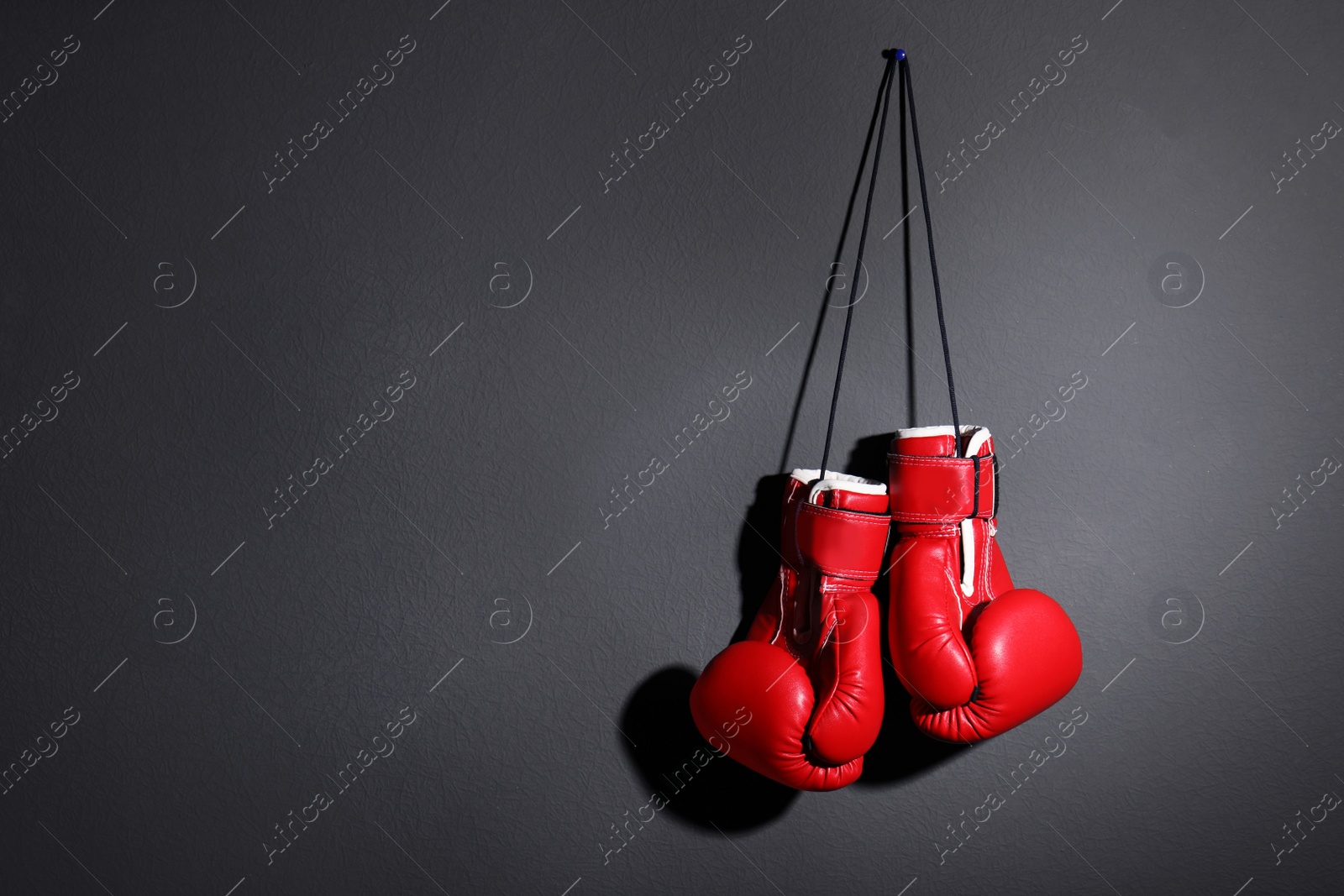 Photo of Pair of boxing gloves on grey background, space for text