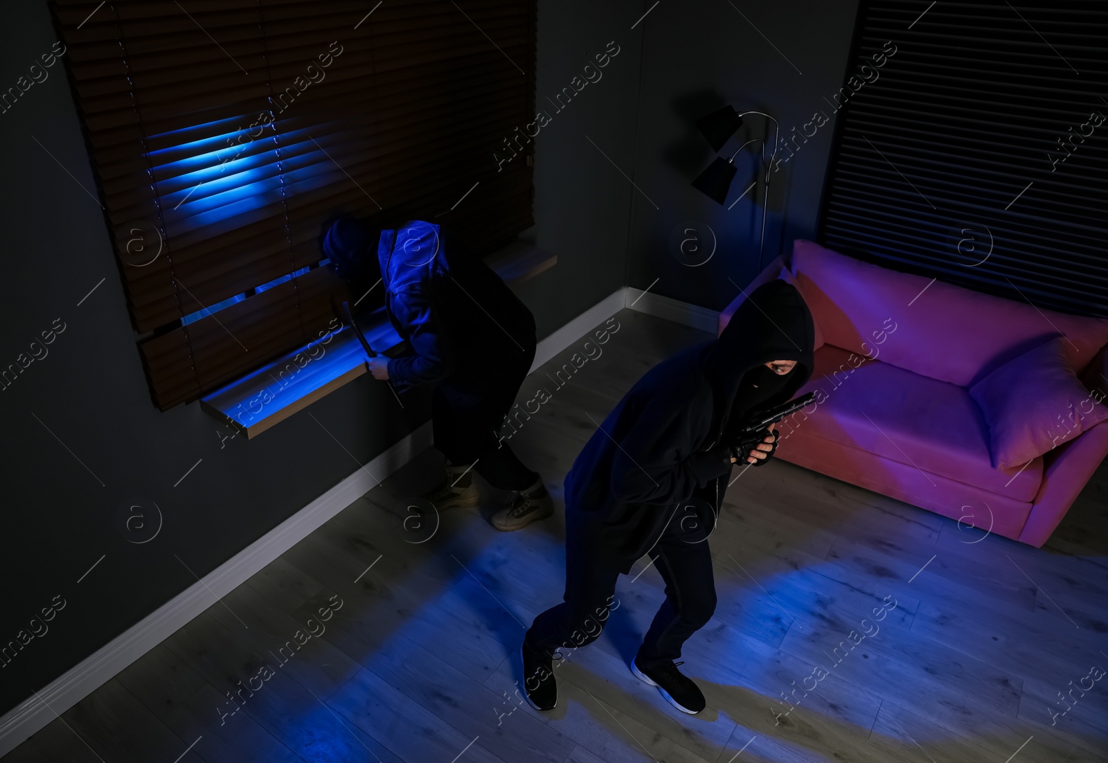 Photo of Dangerous criminals in masks with weapon robbing house, above view