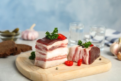 Photo of Composition with bacon and chili pepper on table against blue background