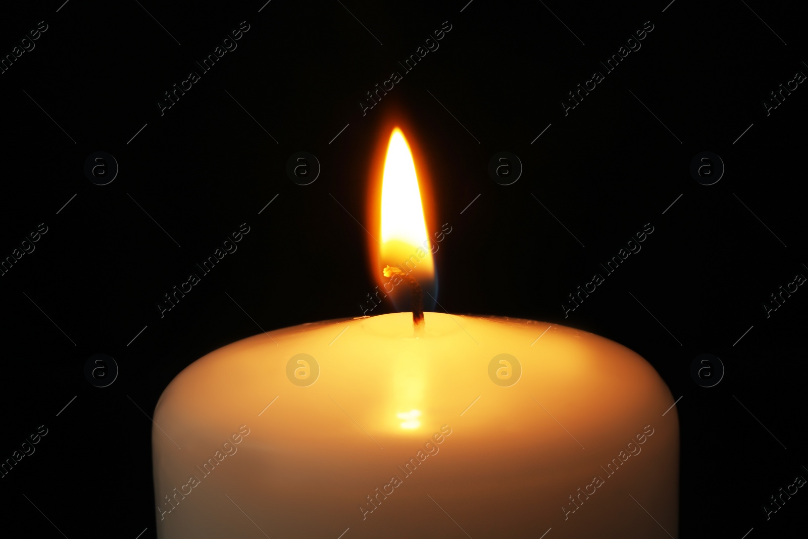 Photo of Burning candle on dark background, closeup. Symbol of sorrow