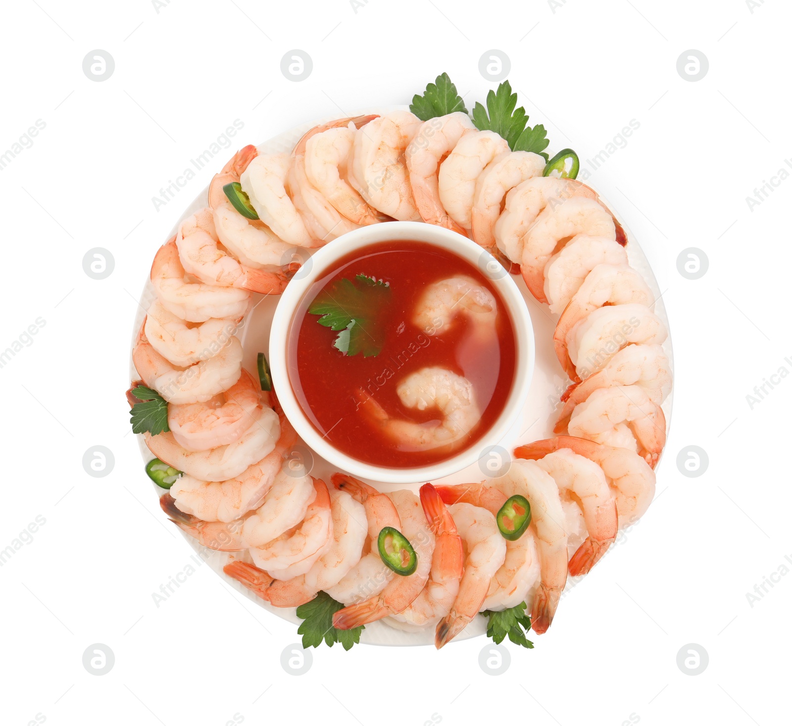 Photo of Tasty boiled shrimps with cocktail sauce, chili and parsley isolated on white, top view