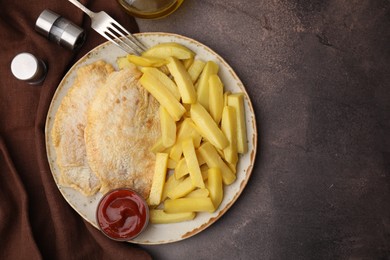 Photo of Delicious fish and chips served on brown table, flat lay. Space for text