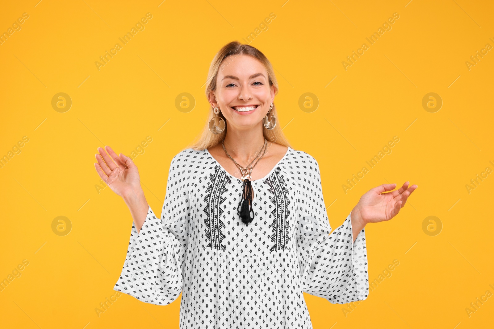 Photo of Portrait of smiling hippie woman on yellow background