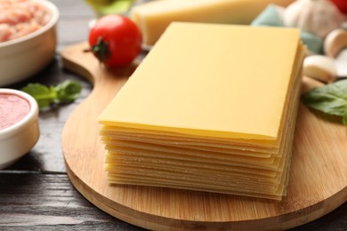 Ingredients for lasagna on wooden table, closeup