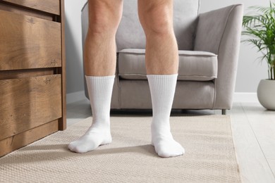 Photo of Man in stylish white socks indoors, closeup