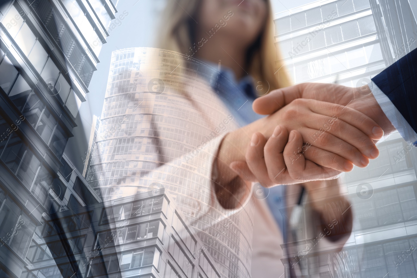 Image of Partnership, cooperation, collaboration. Double exposure of buildings and people shaking hands