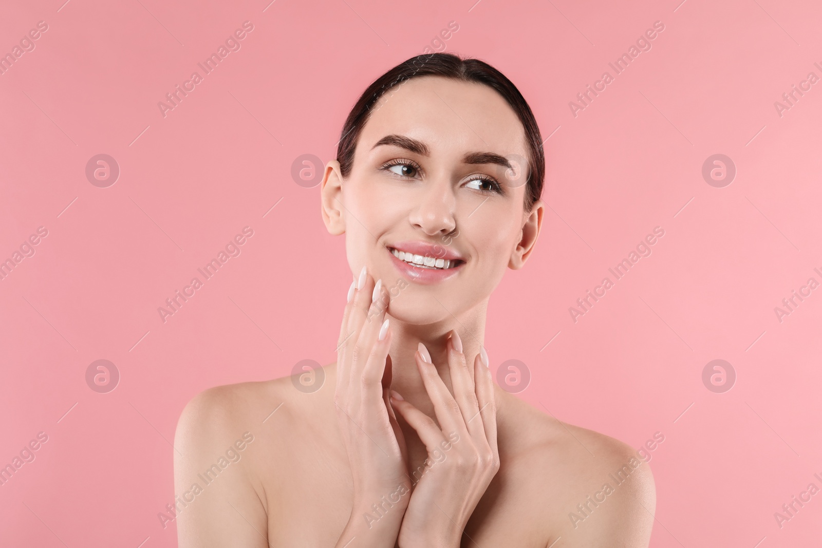 Photo of Portrait of beautiful young woman on pink background