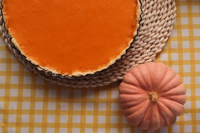 Photo of Delicious homemade pie and pumpkin on table, flat lay