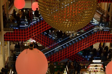 Photo of Paris, France - December 10, 2022: Crowded Le Bon Marche mall with beautiful Christmas decor