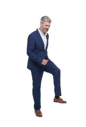 Mature businessman in stylish clothes posing on white background