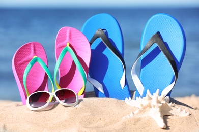 Photo of Composition with beach accessories on sand near sea in summer