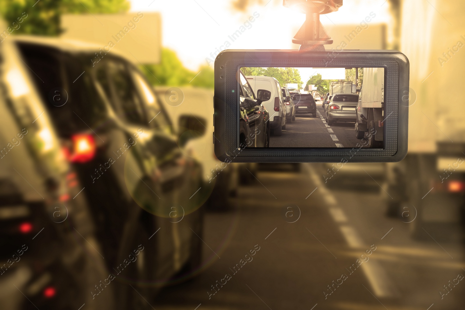 Image of Modern dashboard camera mounted in car, view of road during driving