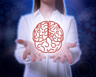 Image of Memory. Woman holding illustration of brain against dark blue background with cogwheels, closeup
