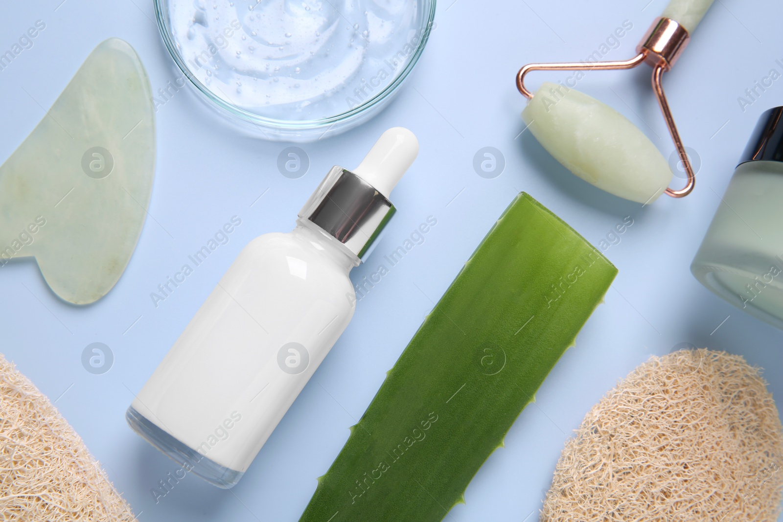 Photo of Flat lay composition with cosmetic products and aloe leaf on light blue background