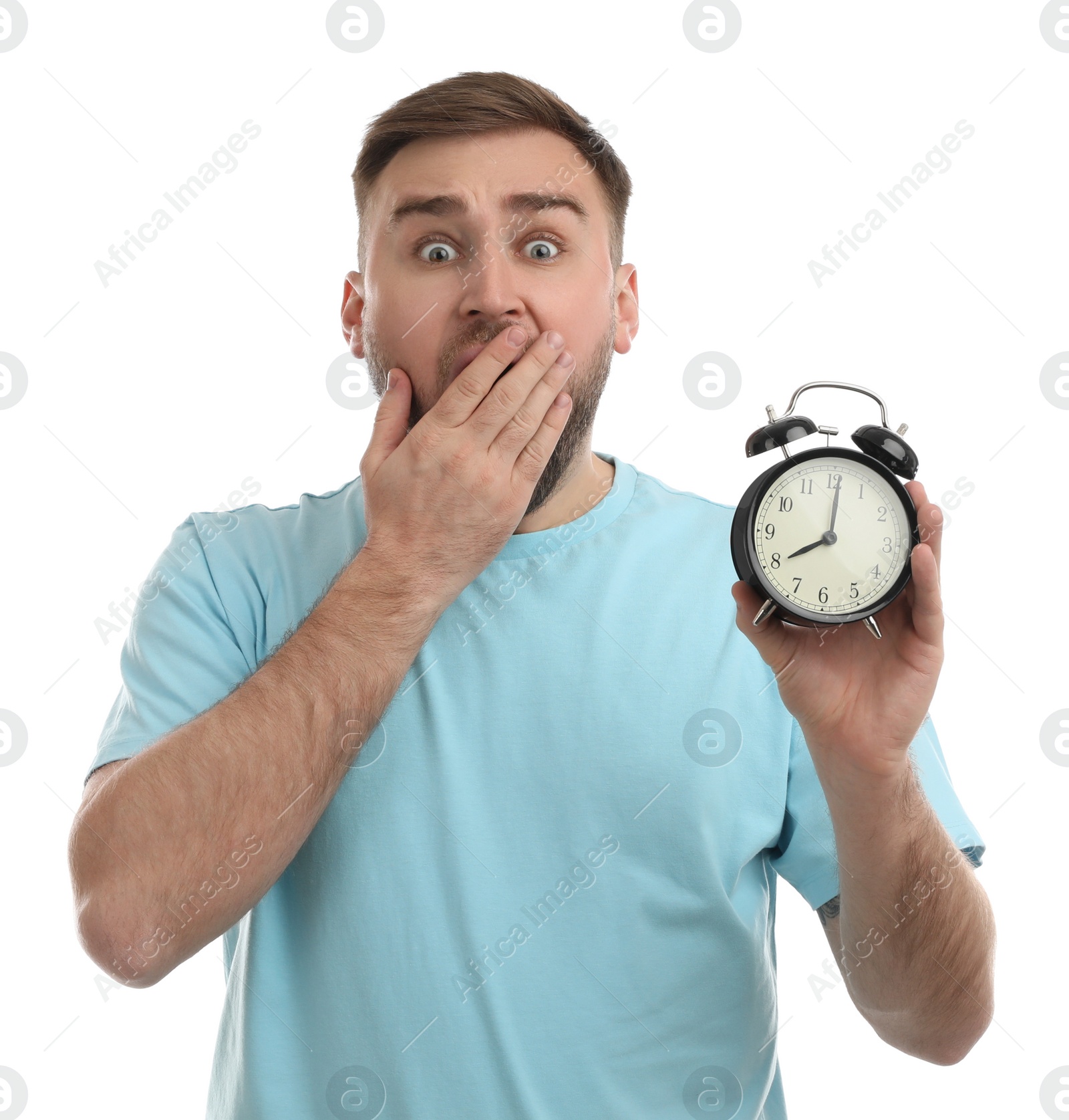 Photo of Emotional overslept man with alarm clock on white background. Being late concept