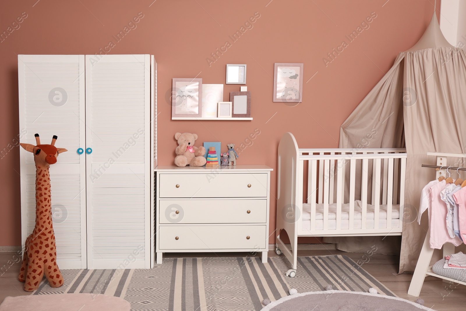 Photo of Baby room interior with stylish furniture and comfortable crib