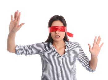 Young woman wearing red blindfold on white background