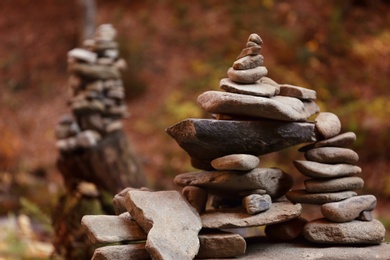 Photo of Stack of stones in forest. Space for text