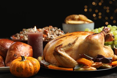 Photo of Traditional Thanksgiving day feast with delicious cooked turkey and other seasonal dishes served on table, closeup