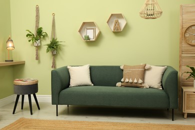 Living room with comfortable green sofa. Interior design