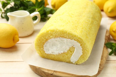 Photo of Delicious cake roll on light wooden table, closeup