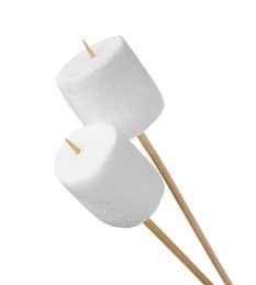 Photo of Sticks with delicious puffy marshmallows on white background