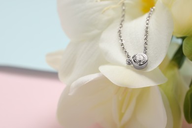 Photo of Beautiful necklace with gemstone on flower, closeup and space for text. Luxury jewelry