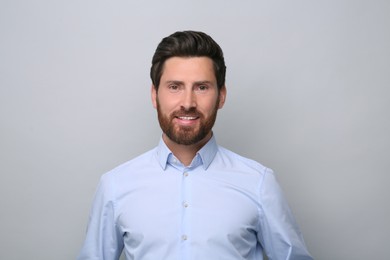 Photo of Portrait of handsome man on light grey background