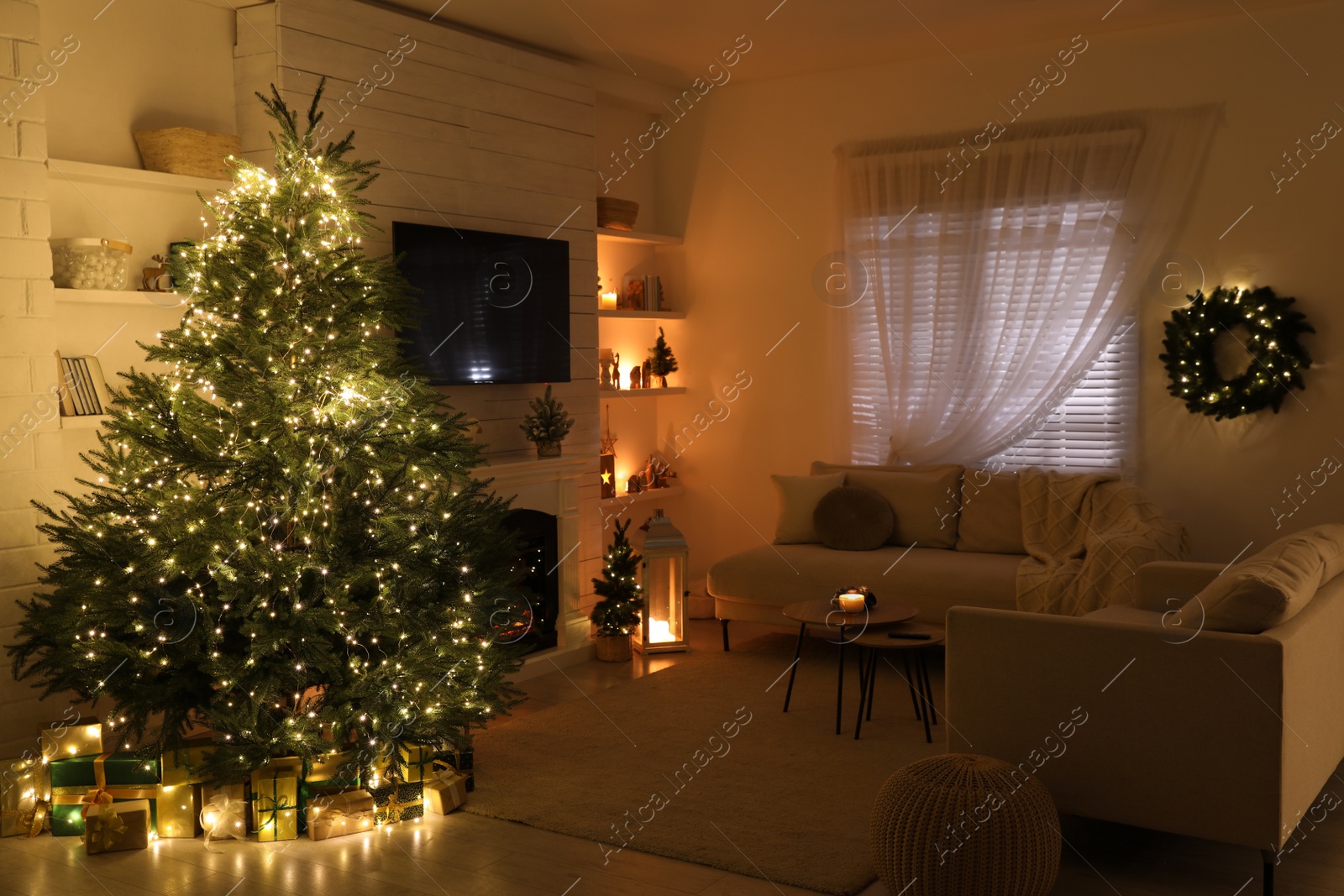 Photo of Stylish living room interior with TV set, Christmas tree and fireplace