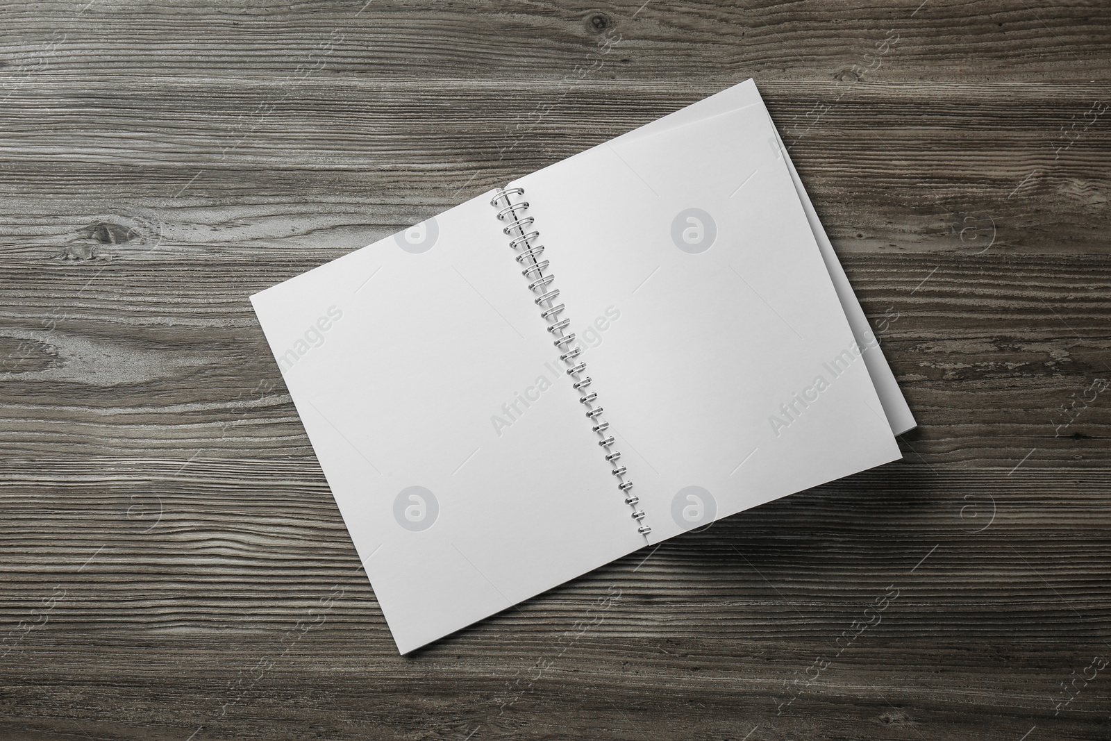 Photo of Blank paper brochure on wooden table, top view. Mockup for design