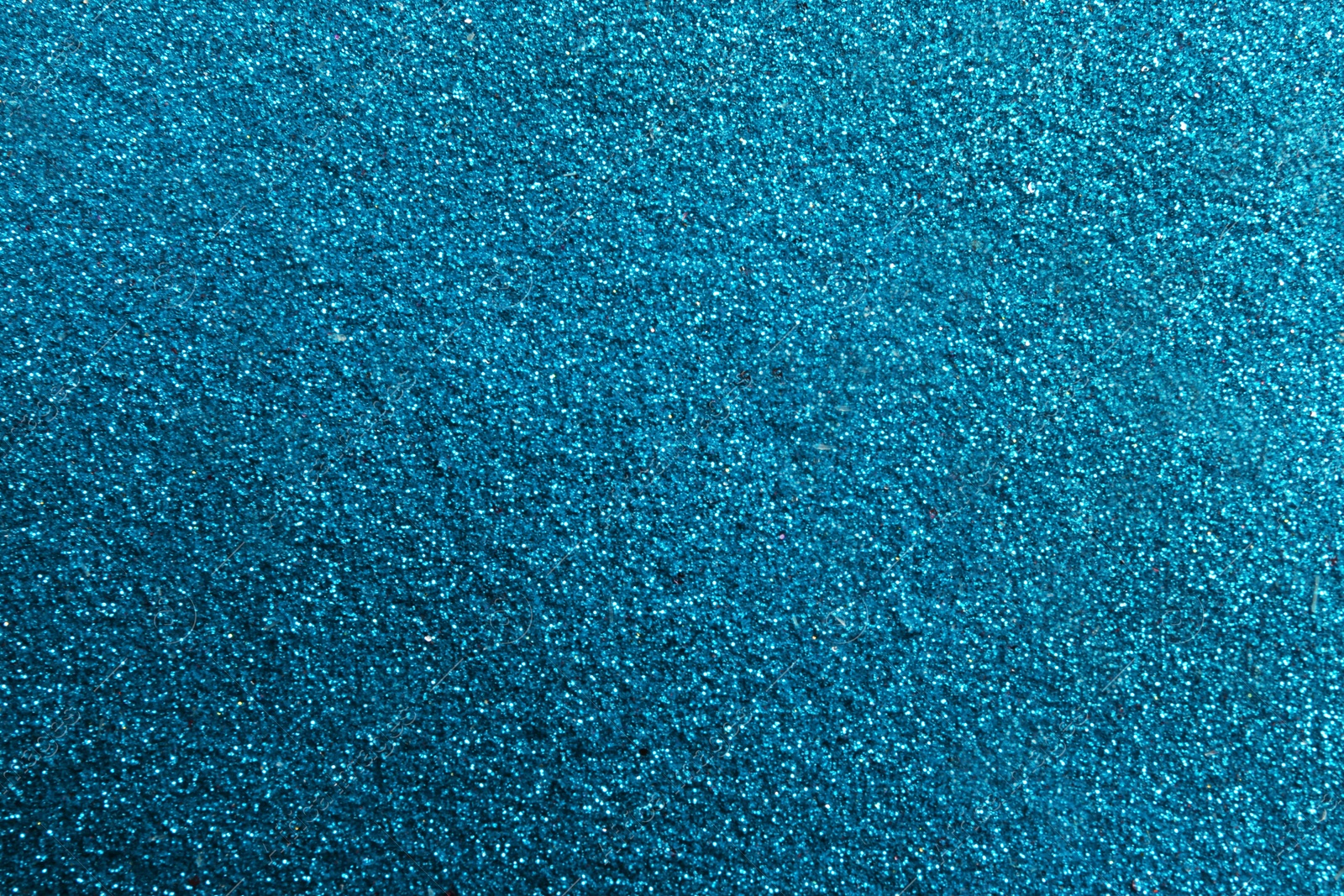 Photo of Closeup view of sparkling blue glitter background