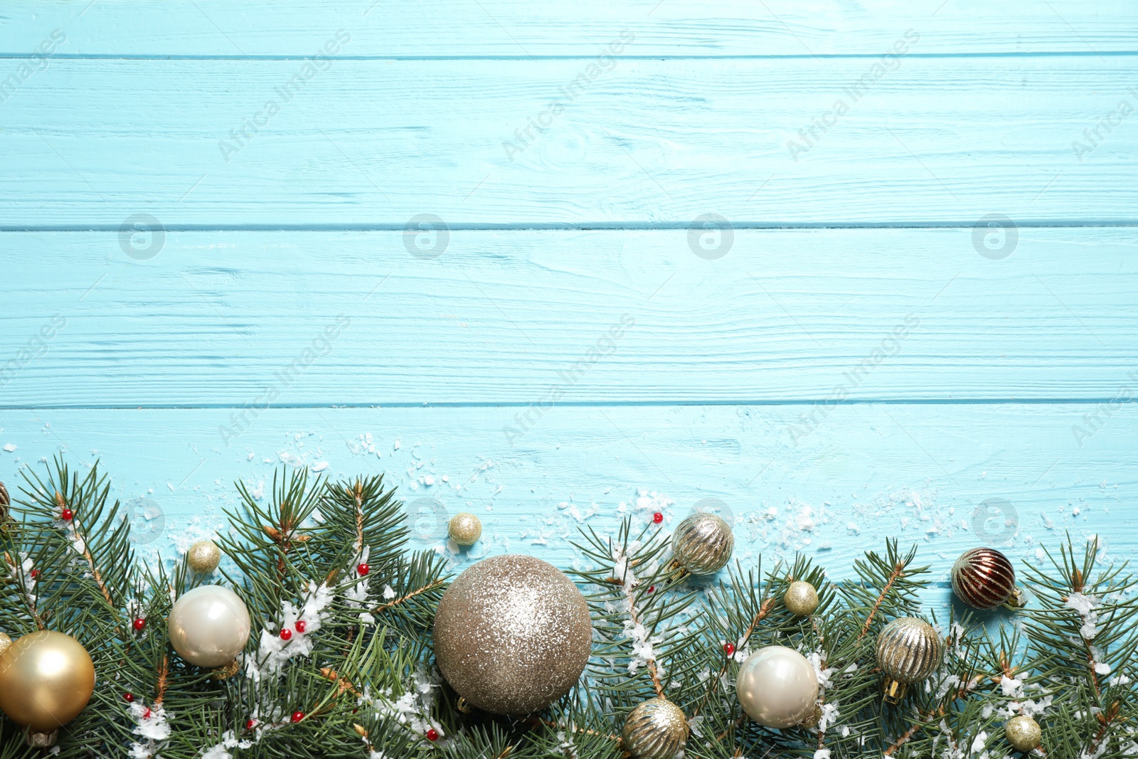 Photo of Fir tree branches with Christmas decoration on light blue wooden background, flat lay. Space for text
