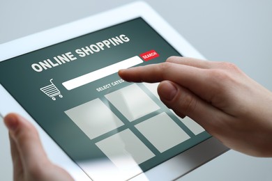 Image of Woman using tablet for online shopping, closeup