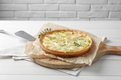 Tasty leek pie with thyme on white wooden table