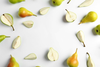 Fresh pears on light background, flat lay composition