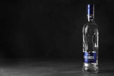 MYKOLAIV, UKRAINE - OCTOBER 03, 2019: Bottle of Finlandia vodka on table against dark background. Space for text