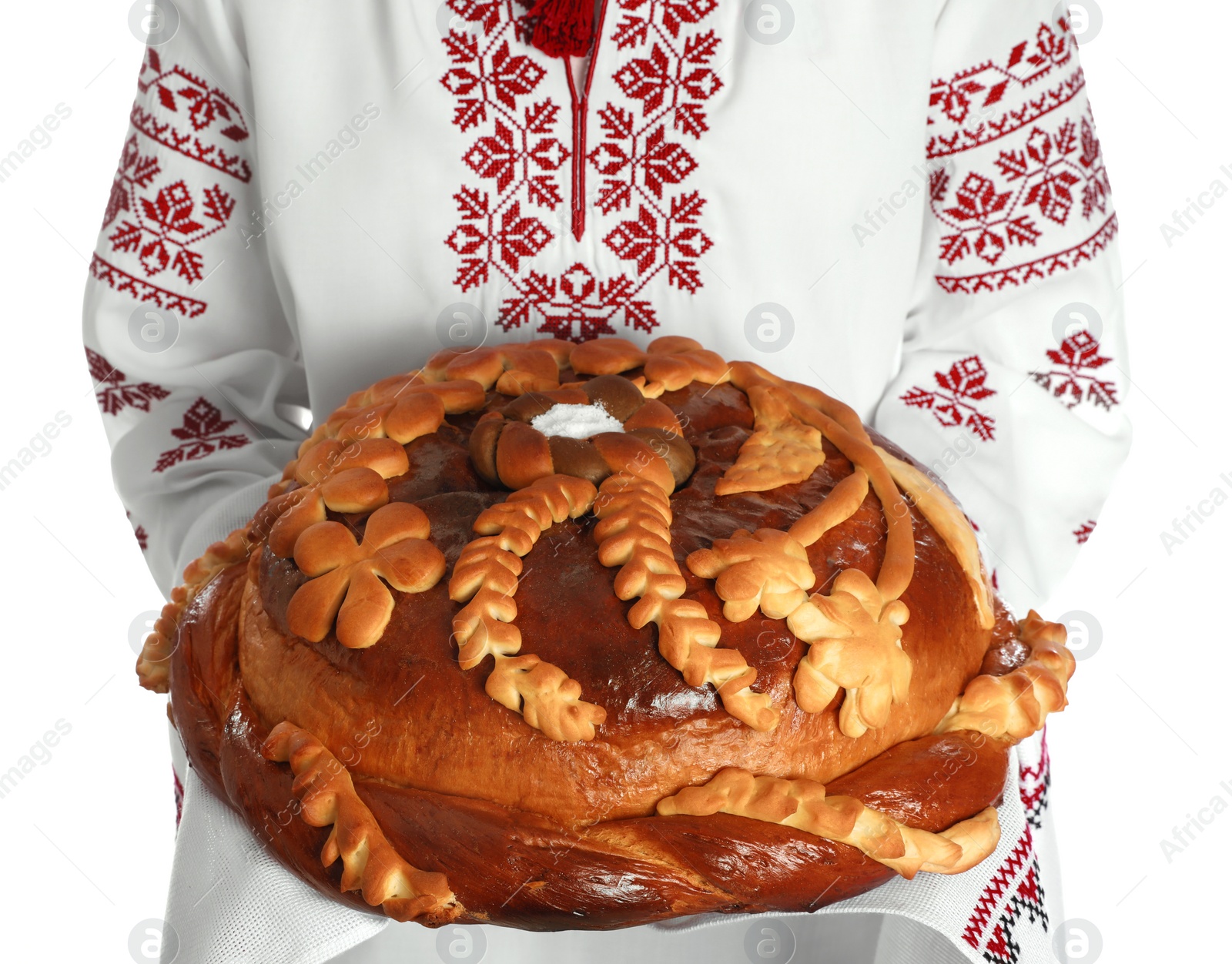 Photo of Woman with korovai on white background, closeup. Ukrainian bread and salt welcoming tradition