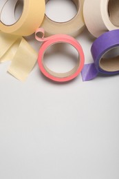 Photo of Many rolls of adhesive tape on light background. Space for text