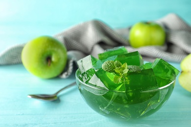 Bowl of tasty jelly on table, closeup. Space for text