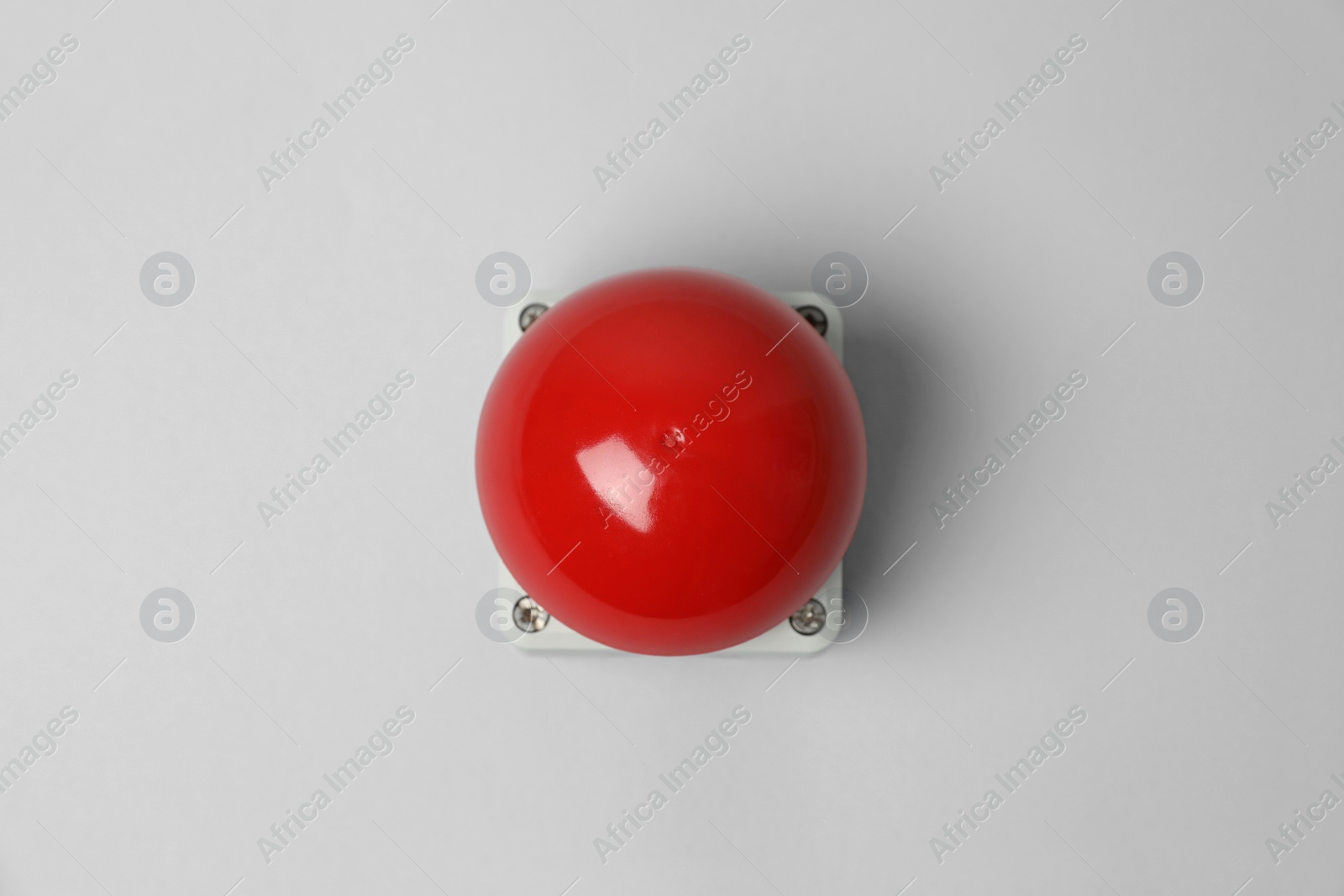Photo of Red button of nuclear weapon on light gray background, top view. War concept