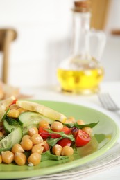 Photo of Delicious fresh chickpea salad on white table, closeup