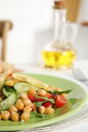 Delicious fresh chickpea salad on white table, closeup