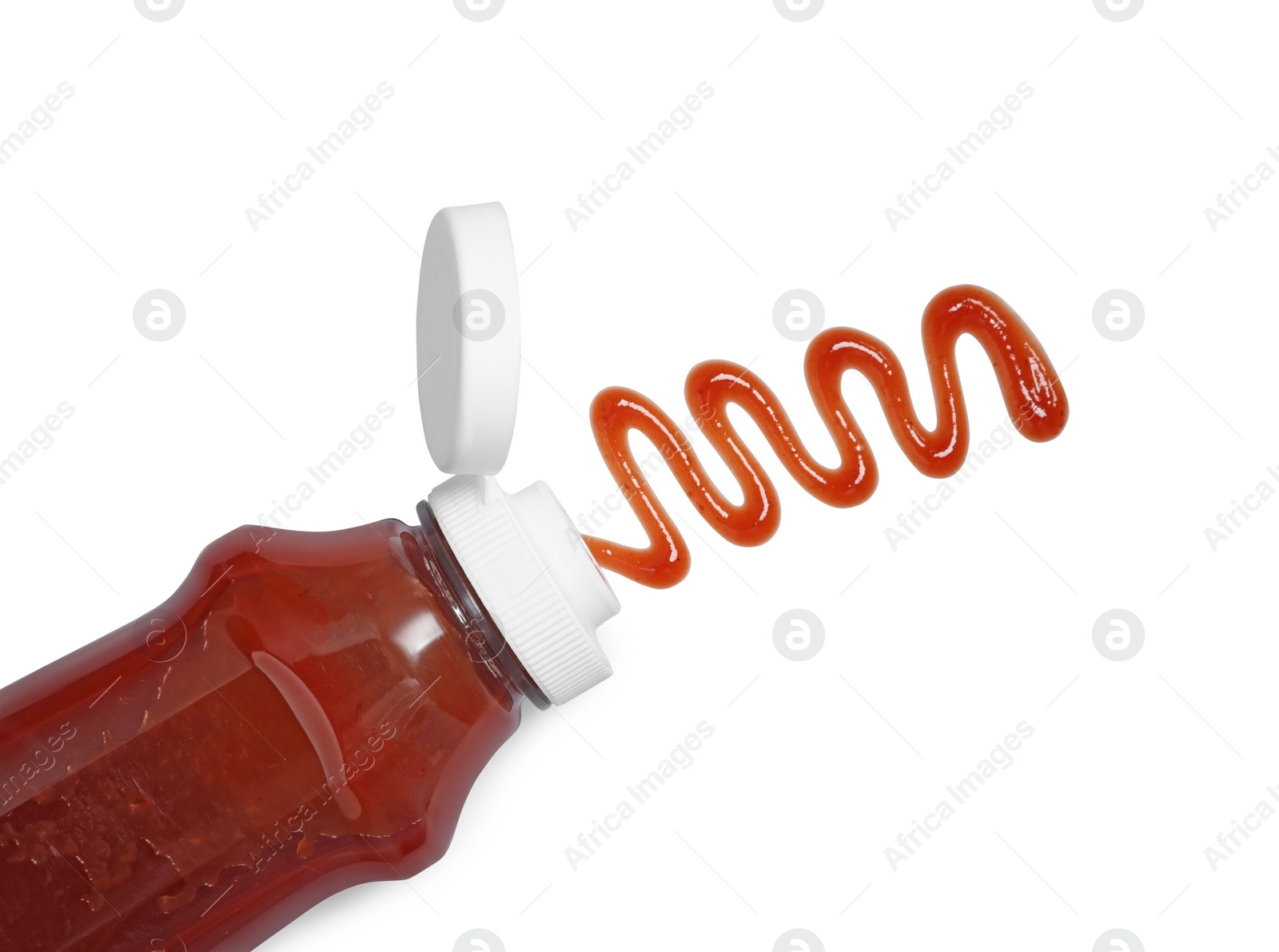 Photo of Squeezed ketchup from bottle isolated on white, top view