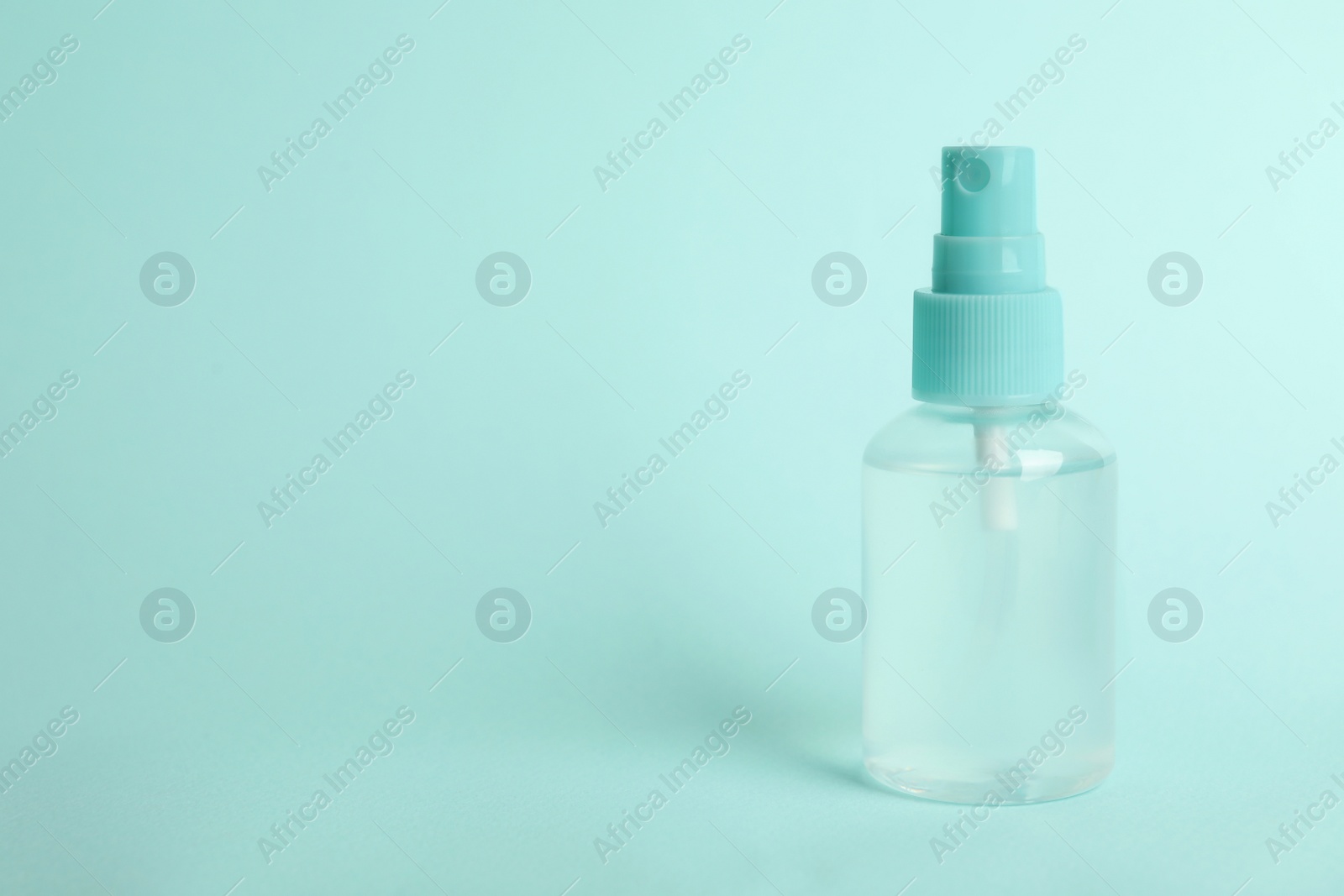 Photo of Antiseptic spray on light blue background. Space for text