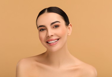 Photo of Beautiful woman with healthy skin on beige background