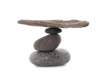Photo of Stack of stones with tree branch on white background. Harmony and balance concept
